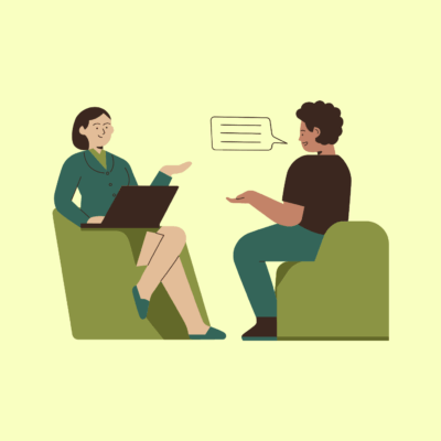 A simple illustration depicts a therapist and client each sitting in their own chair, engaged in conversation.